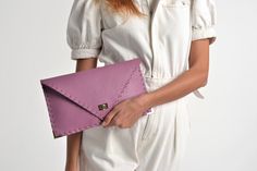 "Symmetria mat clutch in lilac purple. The perfect bag for all occasions! Ideal for cocktail and parties or for business meetings depending the size you choose. It comes in two sizes, small and large. You can use it as a chic briefcase for your work or as a modern large clutch bag for a night out. This adorable clutch is handmade out of a genuine, premium Italian cow leather in a lilac purplee color. -Small size fits all your essentials, wallet, keys, mobile, cosmetics etc. -Large size fits a 15 Elegant Purple Clutch For Everyday Use, Elegant Purple Rectangular Clutch, Chic Purple Pouch Clutch, Chic Purple Clutch As A Gift, Elegant Purple Clutch For Daily Use, Elegant Envelope Bag With Laptop Sleeve, Elegant Lavender Formal Bag, Chic Purple Evening Clutch, Chic Envelope Clutch For Office