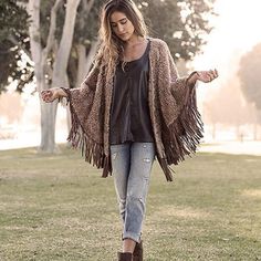 Faux Fur Chalet Grande Poncho Fringe Cape Outerwear For Fall, One Size Cape For Fall Festival, Fall Fringe Cape Outerwear, Chic Fringe Outerwear For Festivals, Chic Festival Outerwear With Fringe, Winter Cape With Tassels, Fall Festival Cape Poncho, Brown Cape-style Outerwear For Spring, Brown Cape For Spring Season