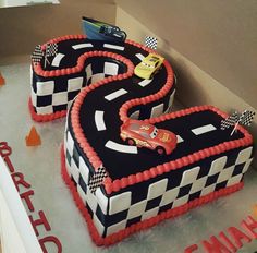 two cakes shaped like cars on top of each other