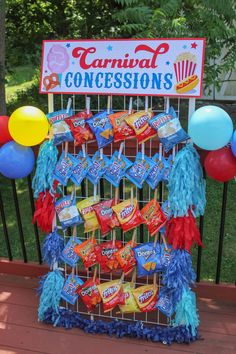 a carnival concession sign with balloons and streamers