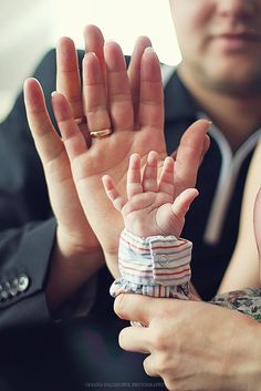 a man and woman are holding their hands together