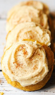 several cookies with frosting and cinnamon on top