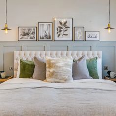 a white bed sitting in a bedroom next to two lamps on either side of it