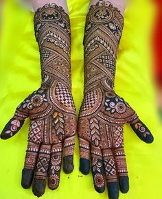 two hands with henna designs on them