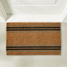 a brown door mat with black and grey stripes