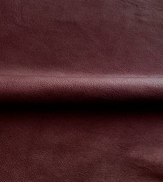 a close up view of a maroon leather textured material with no pattern or color