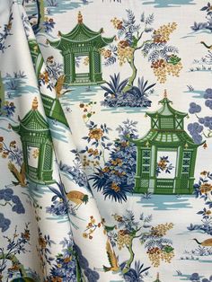 a white and green floral print fabric with pagodas