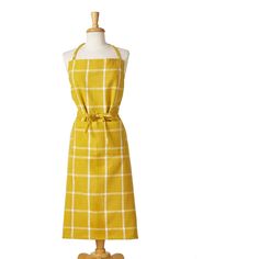 a mannequin wearing a yellow and white checkered apron