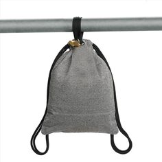 a gray bag hanging from a metal bar