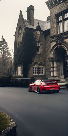 a red sports car is parked in front of a large house on a cloudy day