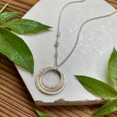 This elegant necklace offers up a unique combination of playfulness & timeless style. Nine organically shaped & uniquely textured sterling silver circles layer gracefully on a lovely sterling silver double cable chain. Each ring is handcrafted individually to represent your journey through the decades. Circles are hammered flat & strong, and given a rustic sparkly texture. The circles shimmer & move gracefully with you, capturing the light & landing in various arrays. This piece is a beautiful w