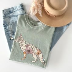 Comfort Colors® German Shepherd Shirt, GSD Mom Tshirt, Gift for German Shepherd Mama, Wildflowers German Shepherd Tee, Cottage Core Gifts  ABOUT: ⋒ The shirt used is the Comfort Colors® 1717 Unisex Garment-Dyed T-shirt ⋒ 100% ring-spun preshrunk US cotton ⋒ Medium fabric ⋒ Rolled sleeves in pictures is for styling purposes only ⋒ Props used in photos are NOT included with purchase SIZING: ⋒ Tees are UNISEX so please refer to sizing chart in photos ⋒ We recommend women to size down if between sizes. Men to size up if between sizes. ⋒ Oversized look: We recommend going two sizes up from your usual size  CARE INSTRUCTIONS:  ⋒ Garments should be machine-washed cold, inside-out on a gentle cycle with a mild detergent and like colors. ⋒ Tumble dry: low heat or air dry ⋒ Do not use fabric softene Green Pre-shrunk Tops For Spring, Spring Green T-shirt With Custom Print, Green Custom Print T-shirt For Spring, Cottage Core Gifts, German Shepherd Shirt, Mom Tshirt, Rolled Sleeves, Sizing Chart, Cottage Core