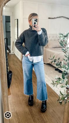 What I wore to work as a teacher in the snow. Loving these cropped wide leg jeans bc the hem stays dry and my weatherproof laguna boots were perfect for the wet snow and sleet. Layer a chunky turtleneck over a white button and pull the hair back in a slick messy bun for a more polished look. Add chunky gold hoops to dress it up and throw on a black overcoat! Medium sweater and button down, tts jeans Follow my shop @emma_grace_blog on the @shop.LTK app to shop this post and get my exclusive app-only content! #liketkit #LTKstyletip #LTKworkwear #LTKmidsize @shop.ltk #chunkyknit #winteroutfit #widelegjeans #casualstyle https://liketk.it/4t0LP Sweatshirt And Wide Leg Jeans, Turtleneck Sweater Layering, Jeans And Big Sweater Outfit, Wide Leg And Boots, Cropped Jeans With Boots Winter, White Chunky Chelsea Boots Outfit, Cropped Flare Jeans Outfit Winter Casual, How To Style Low Top Doc Martens, Wide Leg Jeans Ankle Boots