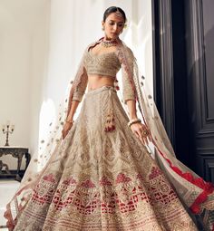 a woman in a white and red lehenga