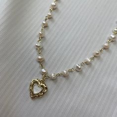 Aesthetic, soft-grunge, princessy pearl necklace made with real freshwater pearls, 18K gold-plated stainless steel and sterling silver 925. - Natural freshwater pearls - 18k Gold Plated sterling silver - Stainless Steel - Durable and hypo-allergic Jewellery 💎high quality, only precious materials 💘every jewelry piece is unique, handmade, one of a kind ✈️shipping worldwide (just press buy!) 💌beautiful packaging <3 Every order comes with free beautiful stickers matching the vibe of the necklace Length: 35-45 (13.7-18in) Gift option - Comes packaged beautifully in a gift bag, ready to be gifted to your loved one or as a treat for yourself Feel free to ask any questions🤍 🖤Shipping WORLDWIDE | FREE international shipping with orders of more than 1 item 🖤Feel free to ask any questions. I re Coquette Gold Jewellery, Dainty Gold Pearl Necklace With Heart Beads, Cross Pearl Necklace, Pearl Necklace With Pendant, Cute Matching Necklaces, Cottage Jewelry, Handmade Accessories Necklace, Pearl And Gold Jewelry, Girly Cottage