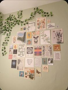 a wall covered with lots of different types of cards and plants growing on top of it