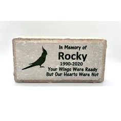 a rock with a bird on it that says in memory of rocky, your wings were ready but our hearts were not