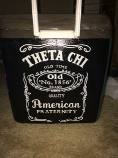 an old time american fraternity cooler with the words, theea chi on it's side