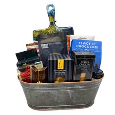 a metal bucket filled with chocolates and other items on top of a white background