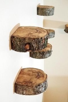 three pieces of wood sitting on top of each other in front of a white wall