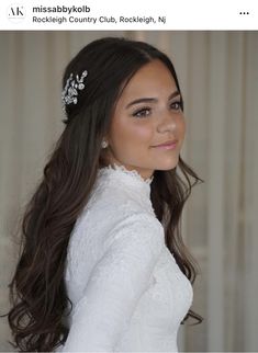 a woman with long hair wearing a white dress