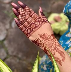 a woman's hand with henna on it