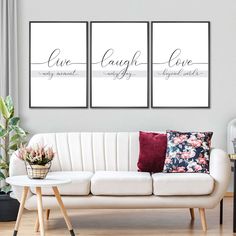 three canvases with the words live laugh love on them in front of a white couch