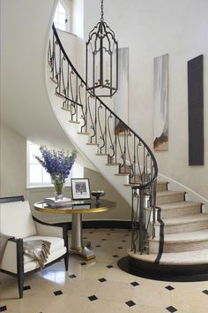 a spiral staircase in a home with black and white tile flooring