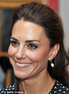 a close up of a person wearing a necklace and smiling at the camera with a smile on her face