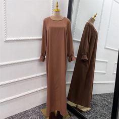 The perfect modest outfit. Slip on and be ready for the day. This set includes a long sleeve simple ruffle long sleeve maxi dress, and a matching one layer khimar with a tie. This set is made of nidha fabric, perfect for even the hottest days. Modest Long Sleeve Dress For Fall, Solid Color Fall Maxi Dress For Daywear, Modest Long Sleeve Maxi Dress For Fall, Flowy Long Sleeve Maxi Dress With Pleated Sleeves, Modest Long Sleeve Flowy Maxi Dress, Flowy Long Sleeve Modest Maxi Dress, Elegant Long Sleeve Plain Maxi Dress, Long Sleeve Maxi Dress For Daywear, Modest Flowy Maxi Dress