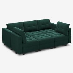 a green couch sitting on top of a white floor