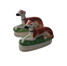 two ceramic dogs sitting on top of each other