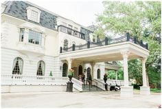 a large white house with black railings