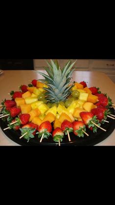 a fruit platter with strawberries, pineapples and bananas