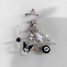 a keychain with charms attached to it's sides and a star on top