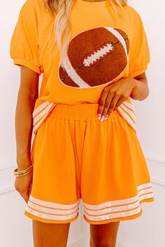 - Add a touch of sporty sparkle to your game day wardrobe with these cute shorts! Sequined jersey-style stripes and subtly distressed hemlines give them trendy energy to keep you looking stylish in the stands. - Lightweight sweatshirt material - An elastic waistline - A single functional back pocket as well as functional side pockets - Sequined jersey-style accent stripes - A relaxed silhouette that ends in unfinished hemlines - This piece is perfect for fans of Tennessee, Texas, Oklahoma State, Casual Cheerleading Shorts, Casual Shorts For Cheerleading, Casual Shorts For Cheerleading During Sports Season, Team Spirit Shorts With Built-in Shorts For Sports Season, Sporty Game Day Shorts In Team Colors, Sporty Game Day Shorts, Sporty Team-colored Shorts For Game Day, Sporty Shorts For Game Day, Team Spirit Athletic Shorts For Summer