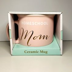 a pink ceramic mug in a box with the words homeschool mom printed on it