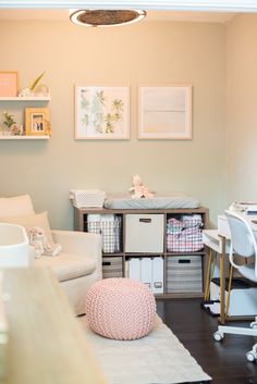 a baby's room with pink and white decor