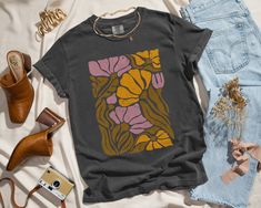 ✨ Flaunt your unique style with our aesthetic tees! This selfie-worthy design is printed with eco-friendly inks on the bestselling 100% cotton Comfort Colors t-shirt, an oversized top that feels like a well-worn favorite the moment you put it on. ✨ SIZING * Please refer to the size chart in the listing photos for exact measurements. * Better yet, simply lay out your favorite t-shirt and measure it, comparing it to our size chart. * This is a relaxed fit unisex sized shirt, which means that those Retro Graphic Design Tops For Fall, Multicolor Graphic Print Shirt For Fall, Fall Multicolor Graphic Print Shirt, Vintage Graphic Tops For Fall, Vintage Graphic T-shirt For Fall, Vintage Fall Graphic T-shirt, Vintage Graphic Design T-shirt For Fall, Artsy Printed Cotton T-shirt, Vintage Floral Print T-shirt For Fall