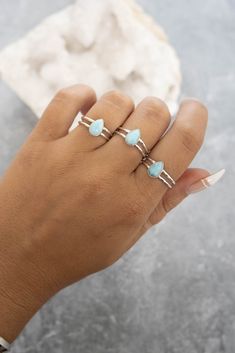 This dainty ring made of 925 sterling silver and a pear shaped larimar stone with a double band is the perfect simple, everyday ring. Love it for its minimalistic design but with a pop of color! Please Note Due to the nature of the stone, the lightness and darkness of the stone will vary as well as the stone pattern and markings. Although it will look very similar to the photo listed, no two stones are the same. If you want to know exactly what the stone will look like in your size, please send Adjustable Larimar Jewelry For Anniversary, Adjustable Blue Larimar Ring, Adjustable Larimar Rings As Gift, Adjustable Larimar Turquoise Ring, Adjustable Turquoise Larimar Ring, Hypoallergenic Larimar Jewelry As A Gift, Hypoallergenic Larimar Jewelry For Gifts, Double Band Rings, Pear Shaped Ring