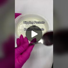 a video demonstrating dipping pretzels and rolling pretzels with pink gloves on