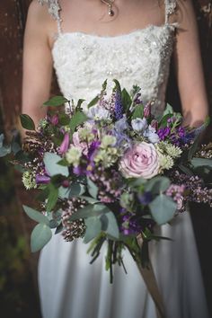 a bride holding a bouquet of flowers in her hands