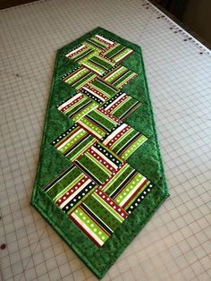 a green table runner on top of a cutting board