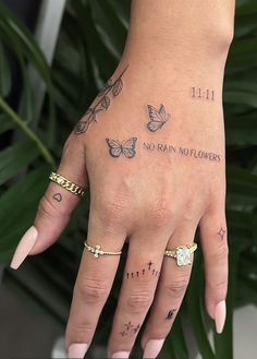 a woman's hand with tattoos on it