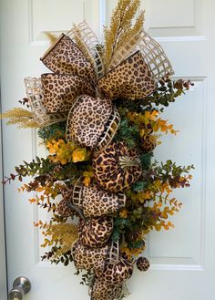 a leopard print wreath hanging on the front door