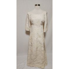 a white dress on a mannequin stand