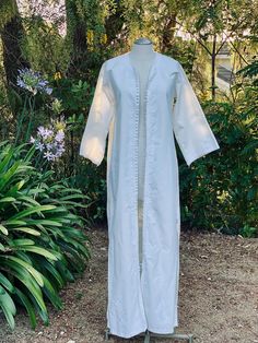 Bohemian minimalist white morrocan wedding dress for the perfectly simple beach wedding. There is a pretty white threaded embroidery to line the hand buttoned front of the dress. Where it as a dress or even as a robe.  Measurements laying flat across: Pit to pit- 20" Waist- 20" Hips- 21" Length- 56.5" Sleeve- 22" Elegant Cotton Kaftan For Spring, Elegant Cotton Beach Kaftan, Elegant Cotton Kaftan For The Beach, Elegant Spring Kaftan With Chikankari Embroidery, White Fitted Cotton Kaftan, Summer Wedding Long Sleeve Kaftan, Fitted Bohemian Kaftan For Wedding, Fitted Bohemian Wedding Kaftan, Fitted Long Kaftan For Wedding