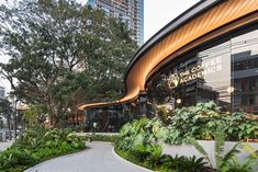 an outside view of a coffee shop with trees and plants