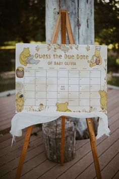 an easel with a baby shower calendar on it