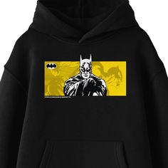 Stay warm and cozy as you celebrate the Caped Crusader with this Batman sweatshirt. The hoodie features a sketch of Batman and his logo in front of a yellow background filled with line art images of the comic book characters. The sweatshirt comes in black with a double-lined hood and a large pouch pocket. Fans of the Batman movies and comic books will love this comfy hoodie. Pop Culture Black Hoodie With Graphic Print, Black Pop Culture Hoodie With Graphic Print, Pop Culture Graphic Print Hooded Top, Hooded Hoodie With Graphic Print - Fan Apparel, Fan Apparel Hoodie With Graphic Print, Pop Culture Hooded Hoodie With Graphic Print, Pop Culture Black Hoodie With Character Print, Black Pop Culture Hoodie With Character Print, Fan Merchandise Graphic Print Hoodie